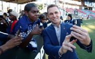 Joel Selwood poses for selfies with Cats fans during the 2024 AFL round-10 match between The Gold Coast SUNS and The Geelong Cats